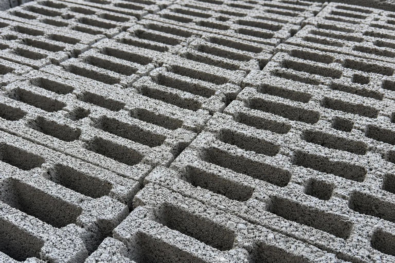 Close-up of hollow pumice blocks with a rough, porous gray surface